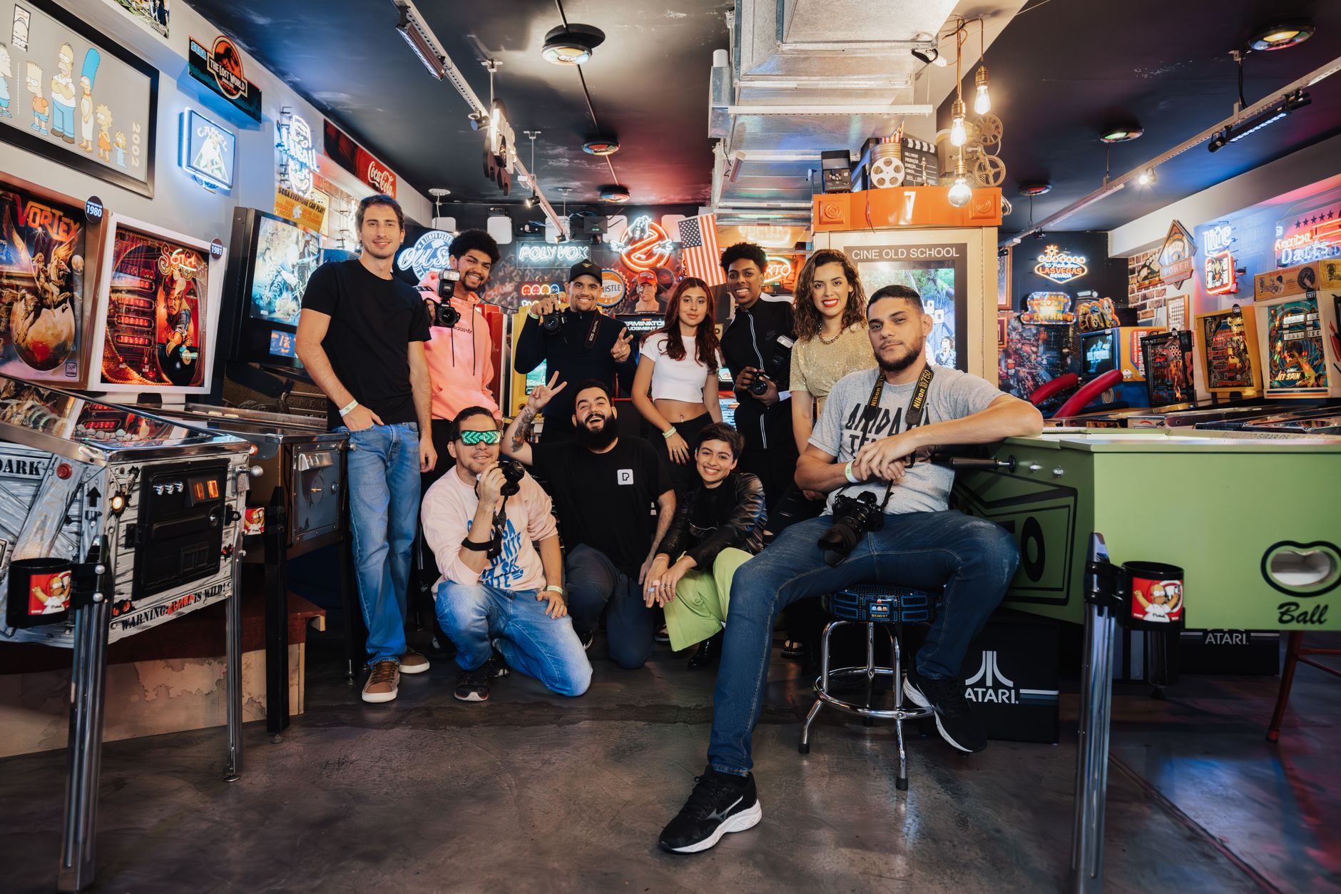 A community gathering around old arcade machine